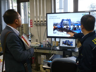 東日本大震災での土壌の除染作業を模した実験写真を説明する鷹屋首席研究員